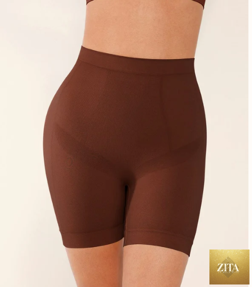 Seamless form-fitting mid-rise tummy control shorts in black, designed to shape and smooth the waist and hips.