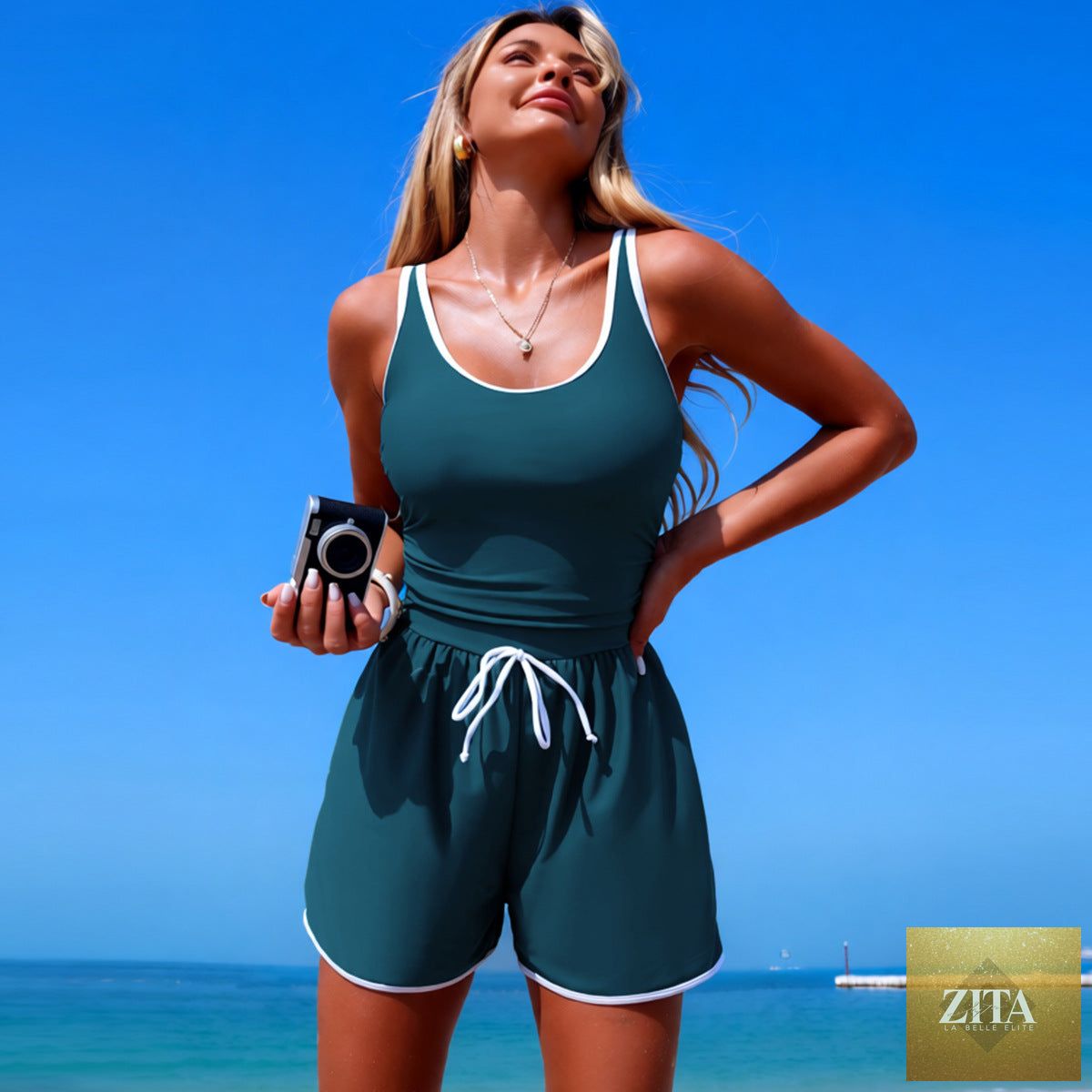 Women's minimalist Zita La Belle Elite sports one-piece swimsuit in solid color with sleeveless design, displayed on a model.