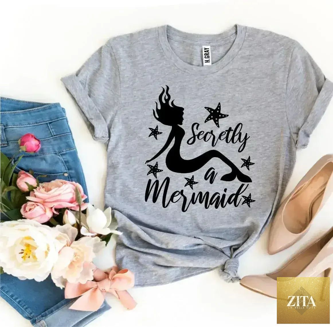 Femstylo Secretly a Mermaid T-shirt featuring a colorful mermaid graphic on a casual short-sleeve tee.