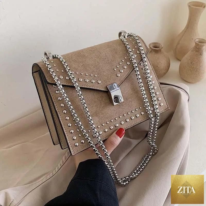 Elegant genuine leather Stevvex shoulder bag with a dazzling scrub finish, chain rivets, and crossbody design for women and girls.