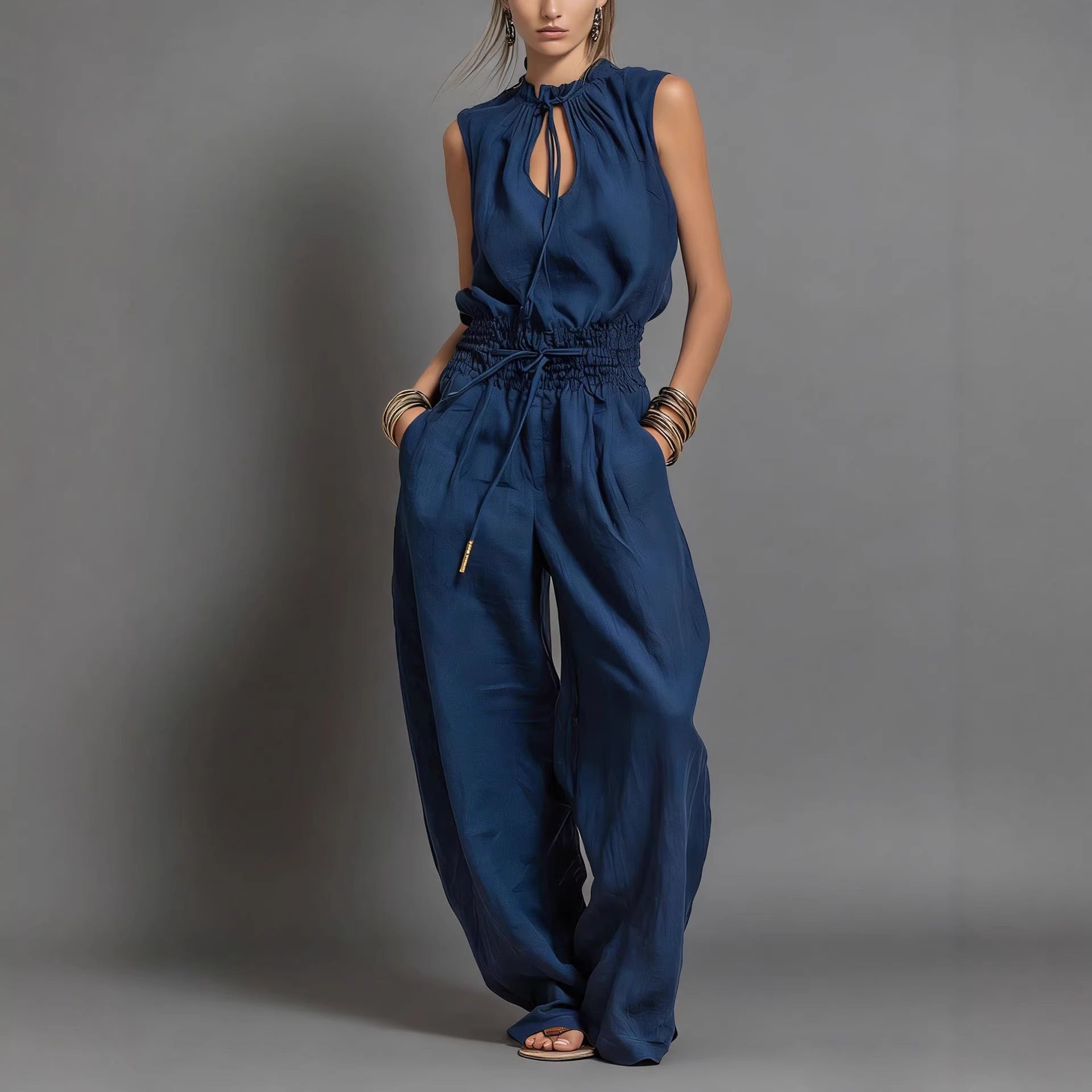 Women's sleeveless high-waist wide-leg pleated jumpsuit in casualwear style, by FitiqueFit, shown on a model.