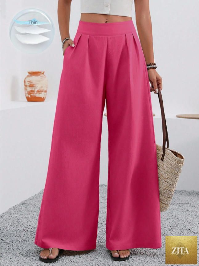 Women’s high-waist wide-leg trousers with pockets by Zita La Belle Elite, full-length with a tailored fit and flowing fabric.