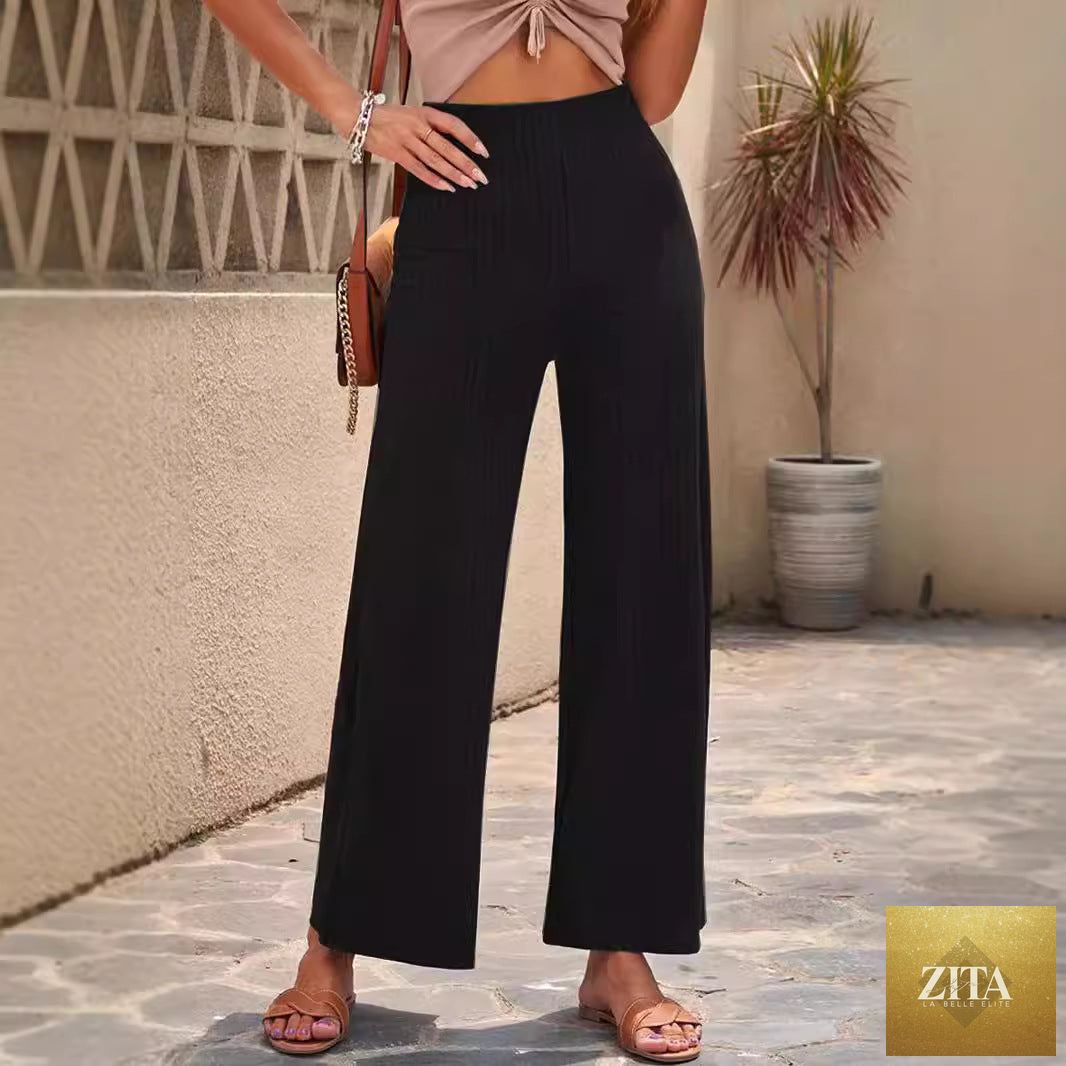 Women's high-waisted ribbed straight-leg pants in neutral color, displayed on a hanger with a close-up of fabric texture.
