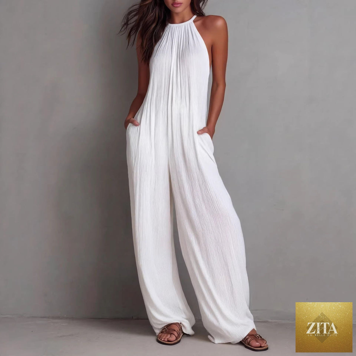 Women's sleeveless open-back wide-leg pleated jumpsuit by Zita La Belle Elite, showcasing its relaxed fit and stylish design.