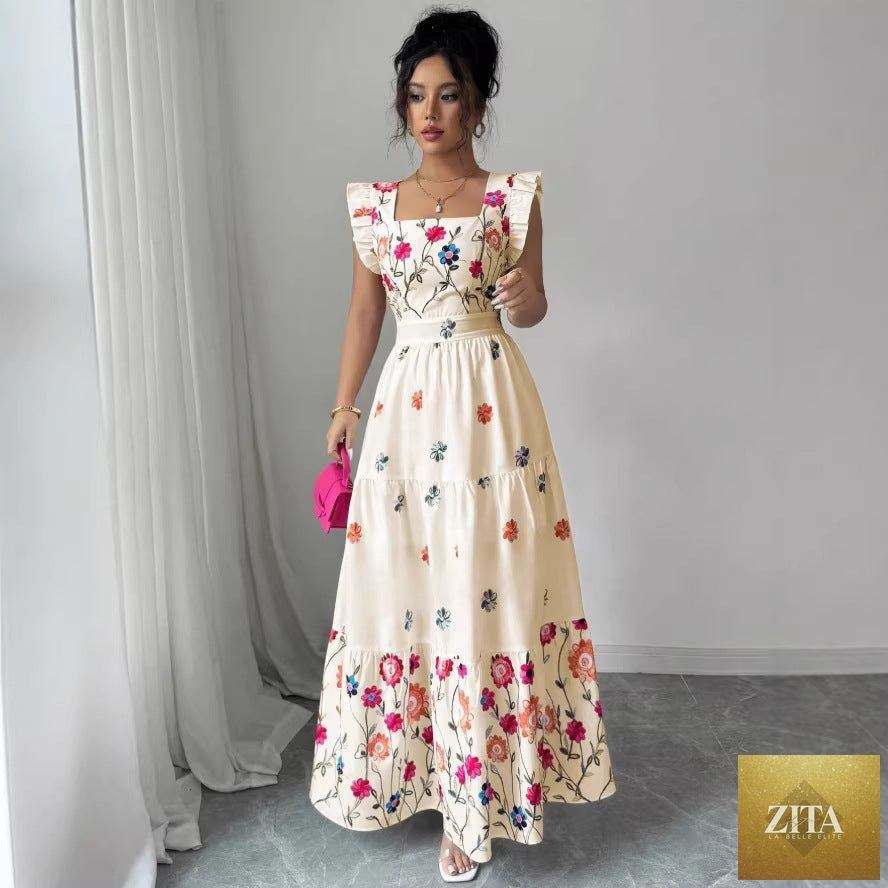 Women’s floral print dress with puff sleeves and waist-cinching design by FitiqueFit, shown on a model.