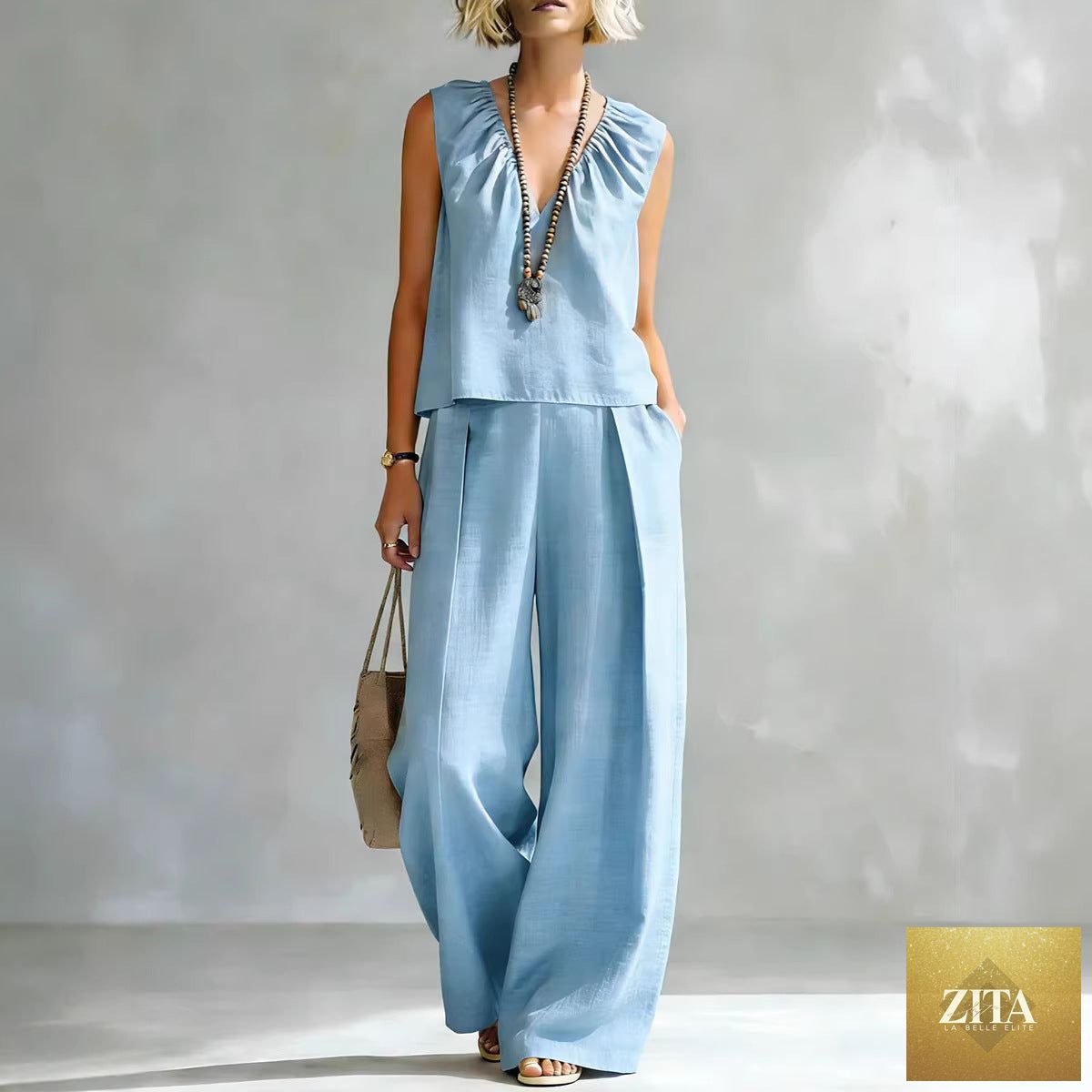 Women's sleeveless cotton-linen shirt and pants set by FitiqueFit, casual urban 2-piece outfit, shown in light fabric and relaxed fit.