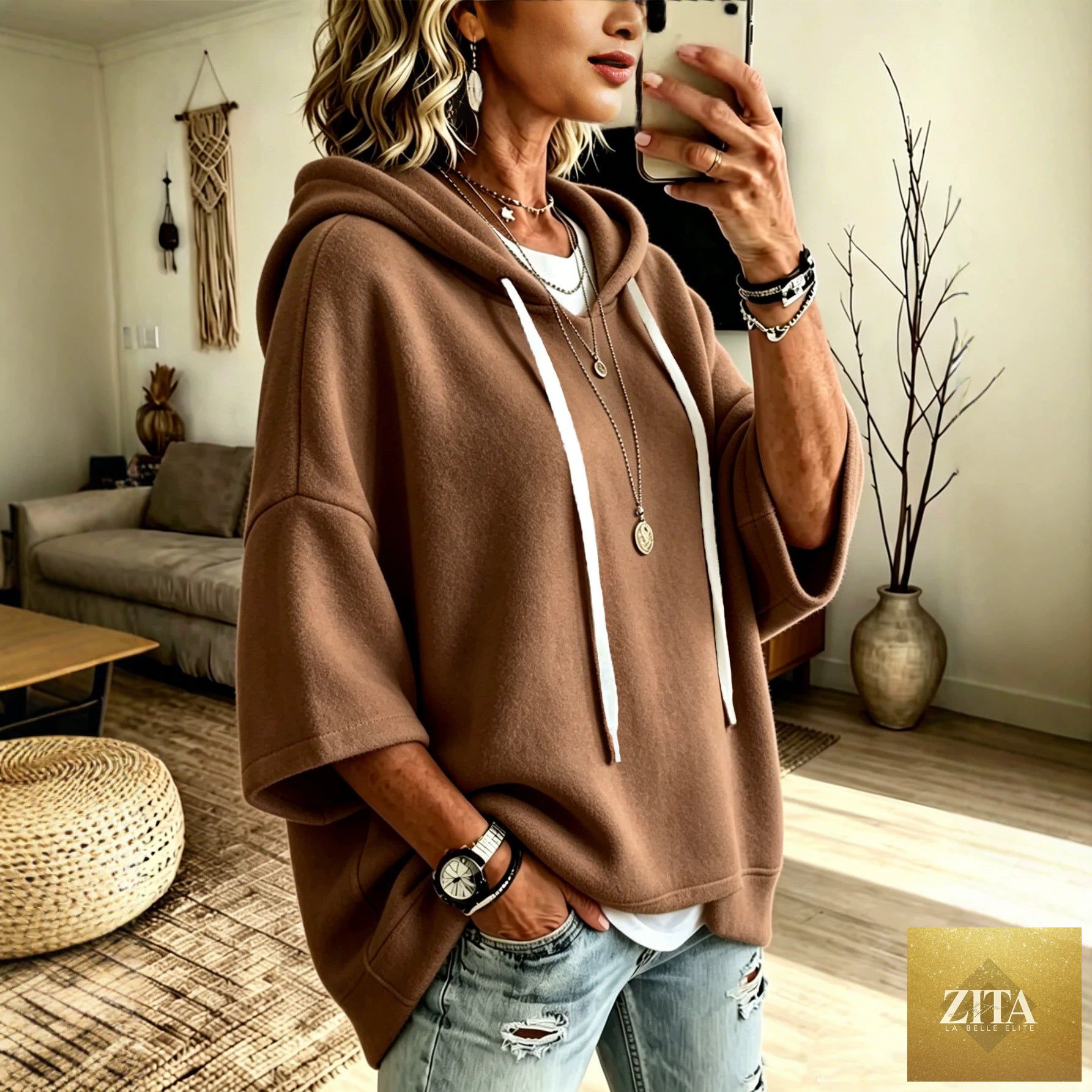 Women's oversized batwing sleeve hoodie by FitiqueFit, loose fleece pullover with relaxed fit and cozy design, shown in a casual style.