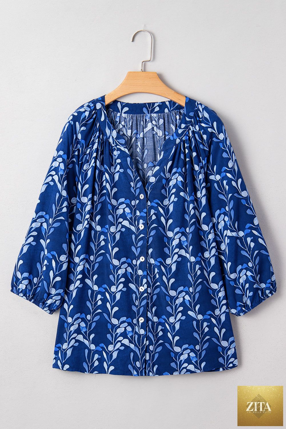 Blue botanical print blouse with notched neck and bracelet-length sleeves, casual and stylish top from Wild and Free Boutique.