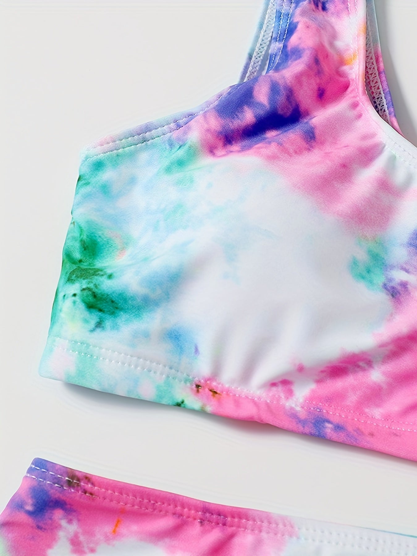 Stevvex tie-dye bikini set with high waist, round neck crop top, and high-cut legs, perfect for summer beach and poolside fun.