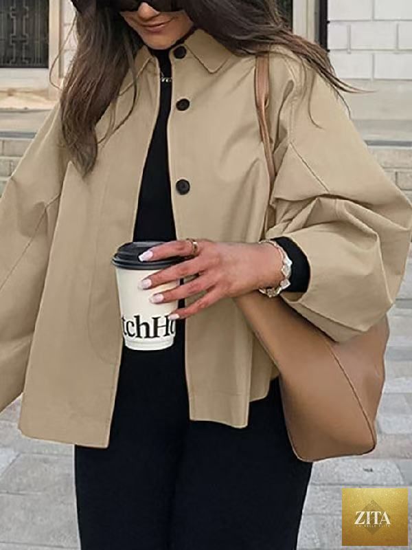 Women's French-style loose mid-length trench coat by FitiqueFit, shown in a neutral color, with classic lapels and belted waist.