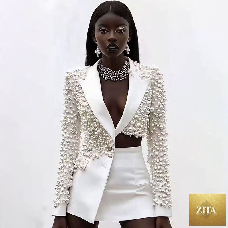 Zita La Belle Elite women's beaded blazer and skirt set featuring a deep V-neck and heavy embellishments, shown on a model.