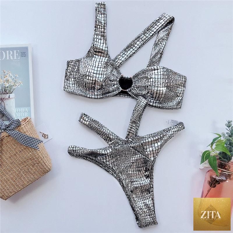 Elegant women’s snake print gold bikini set with shiny two-piece swimwear, featuring bandeau top and string bottoms.