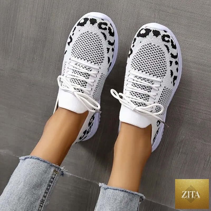 White women's sneakers by SnagBag featuring leopard print accents and lace-up design, ideal for sporty, casual wear.
