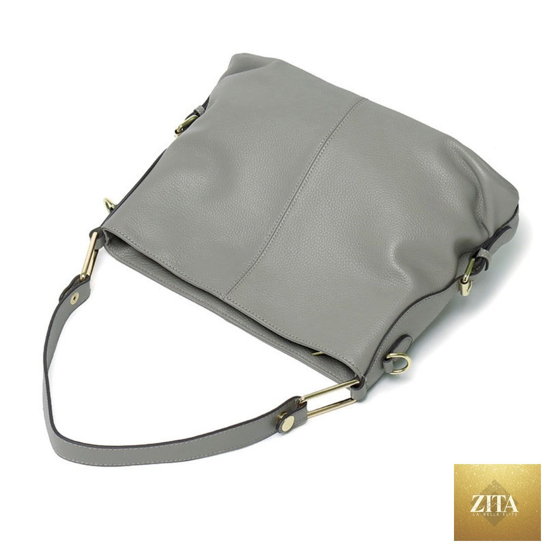 Elegant genuine leather handbag by SHOMICOBOUTIQUE featuring a stylish hobo and crossbody tote design with gold-tone hardware.