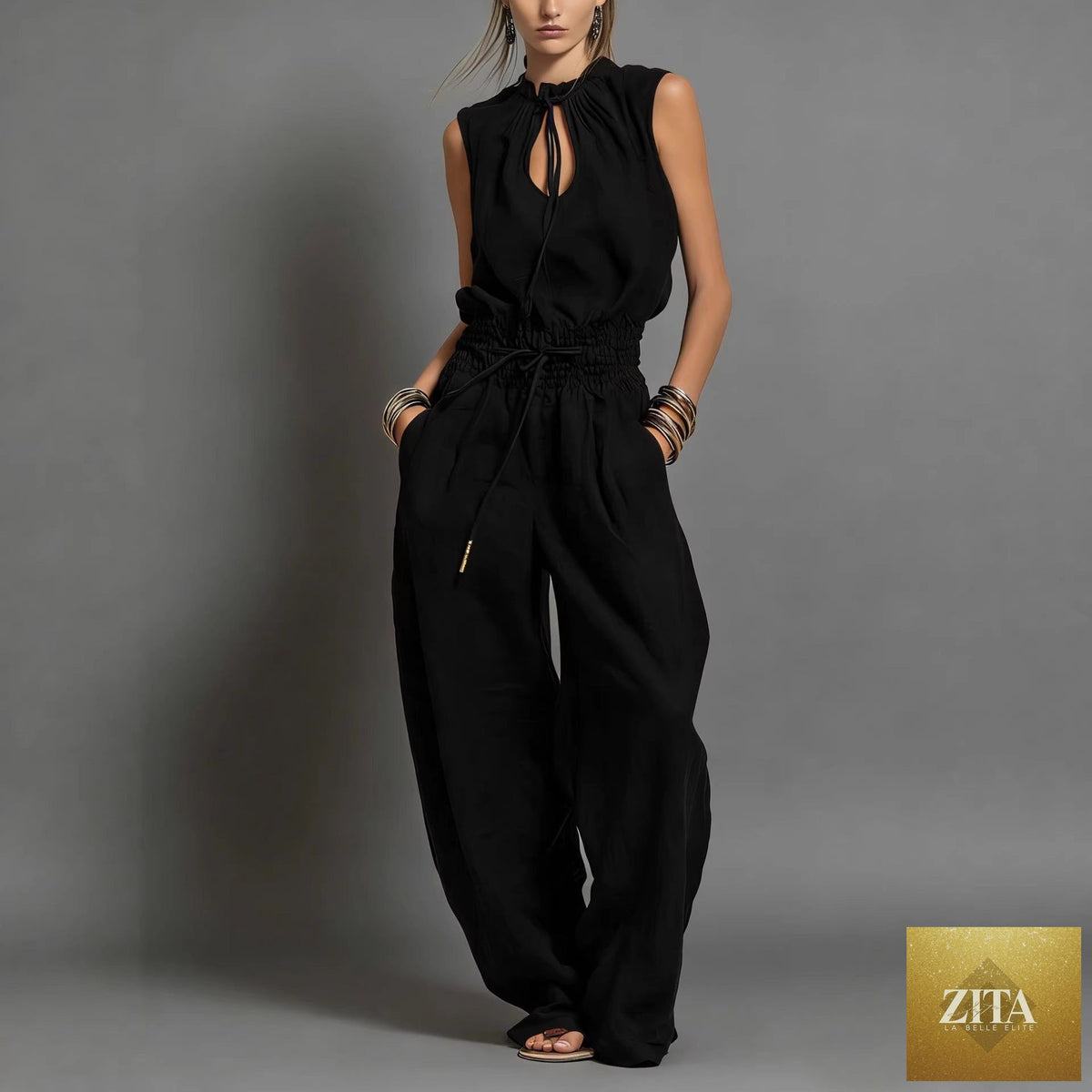 Women's sleeveless high-waist wide-leg pleated jumpsuit by FitiqueFit, shown in a casualwear style with flowing fabric and wide-leg design.