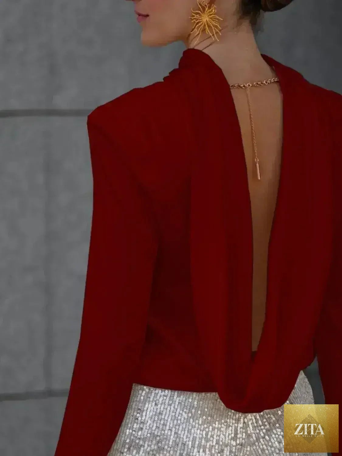 Femstylo women's backless cowl neck long sleeve blouse showcasing a stylish, elegant design with flowing fabric and a modern silhouette.