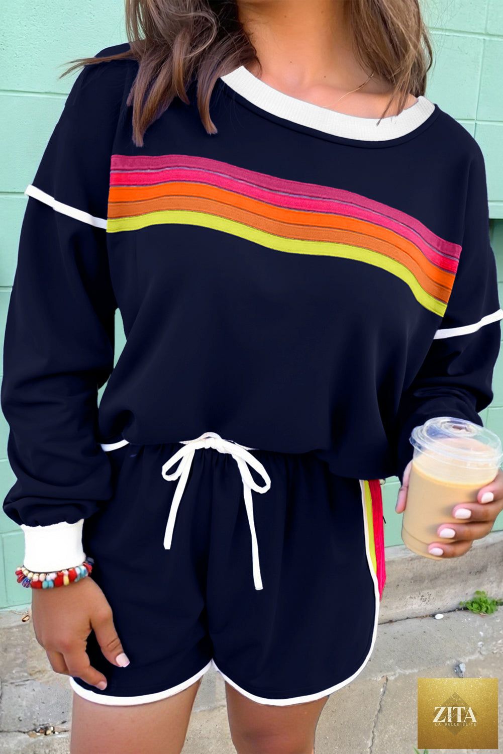 Colorful striped varsity long sleeve pullover and matching shorts set by Wild and Free Boutique, casual two-piece athletic outfit.