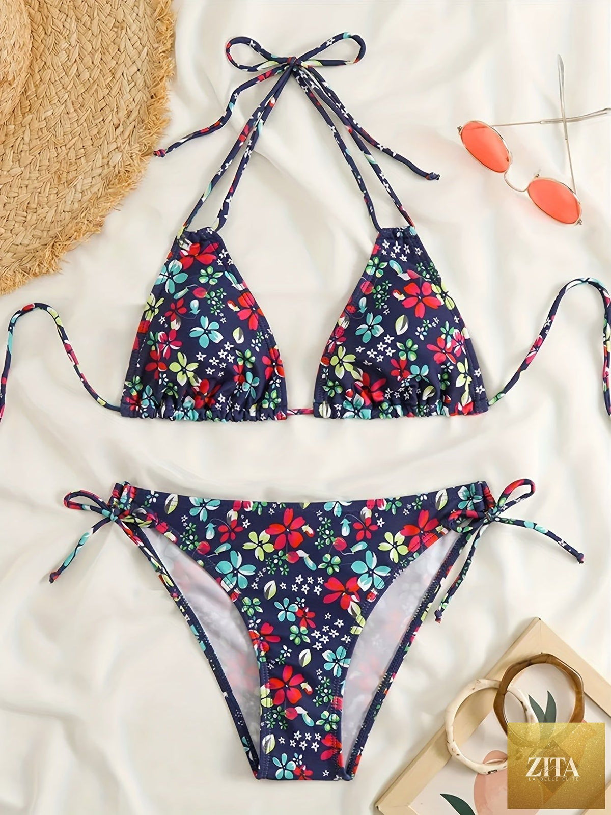 Stevvex Sunset Bloom 2-piece bikini set for women with vibrant floral print, halter neck, tie-back, and high-cut bottoms for summer beach.