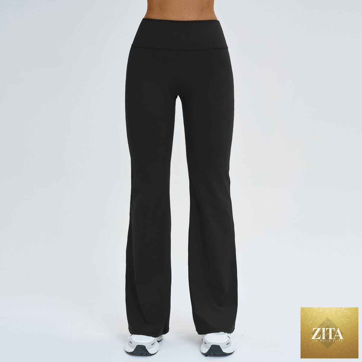 Women’s high-waisted flared leggings with tapered legs, offering a slimming, sporty look in black for activewear or casual wear.