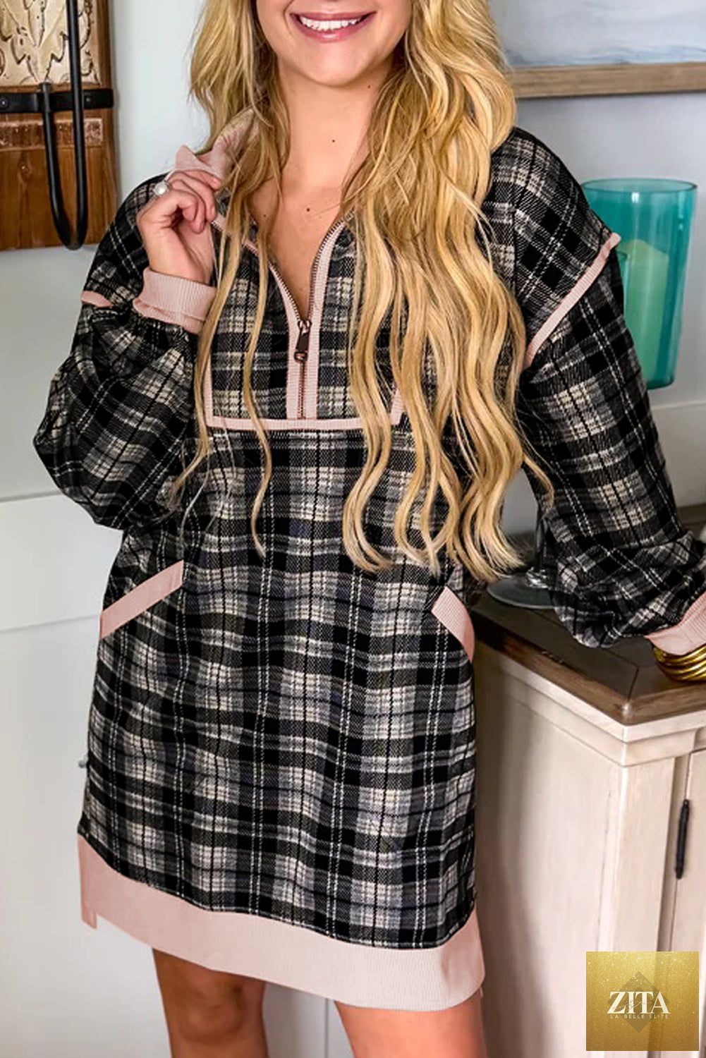Black plaid mini dress with polo collar, contrast trim, long sleeves, and zip-up front by Wild and Free Boutique.