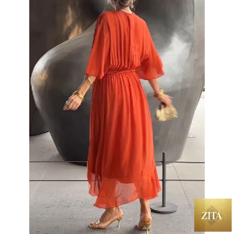 FitiqueFit Batwing Sleeve V-Neck Midi Dress with tied irregular hem, flowing fairy dress style in soft fabric, shown on a model.