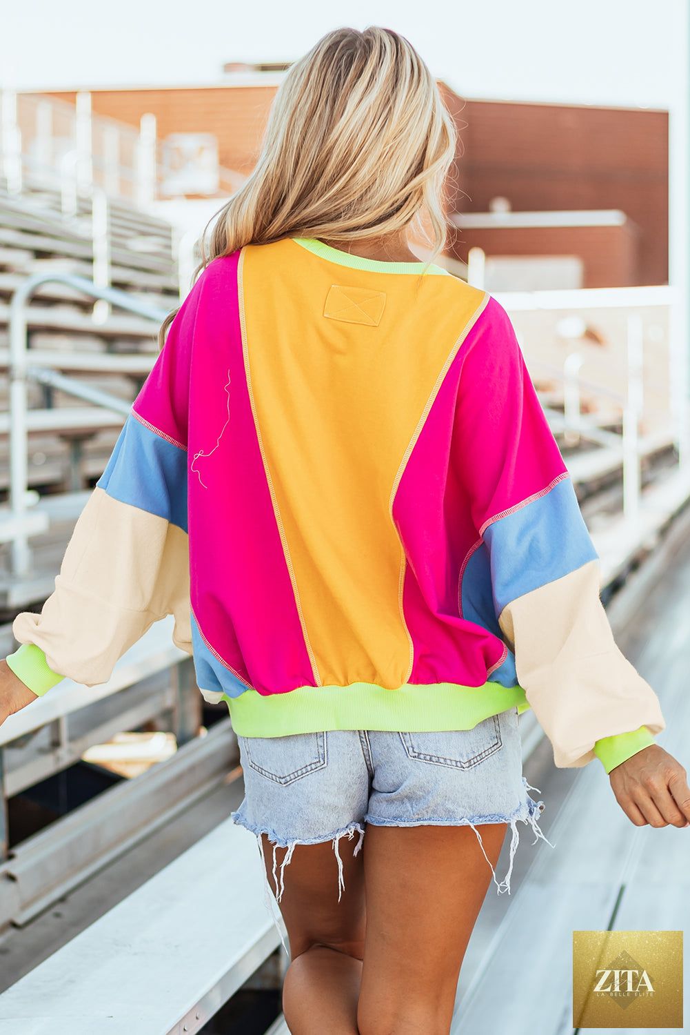 Grapefruit orange colorblock patchwork long sleeve top from Unique Oils with exposed stitching, oversized fit, stylish casual design.