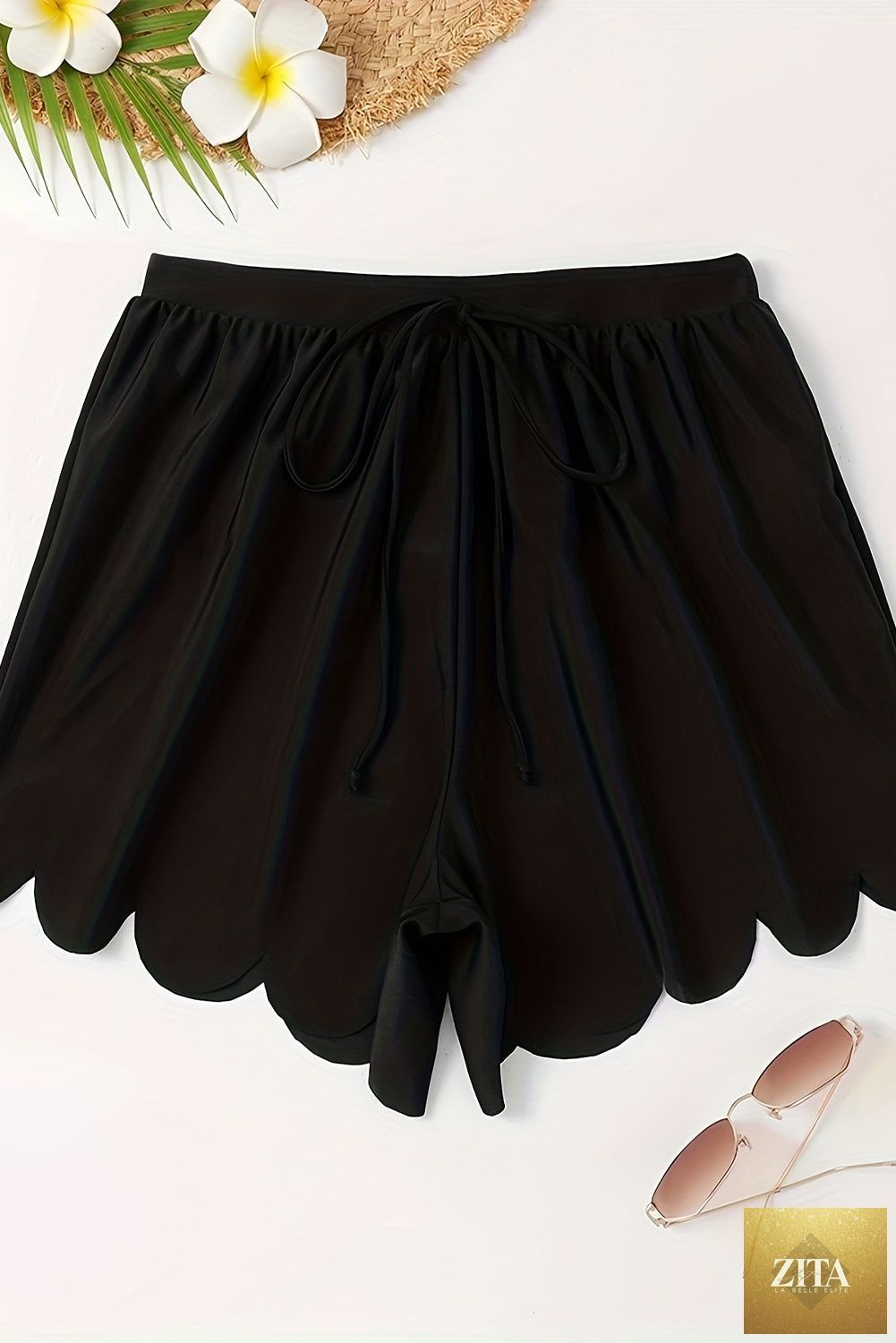 Black scallop trim drawstring beach shorts from Wild and Free Boutique, featuring a relaxed fit and lightweight fabric.