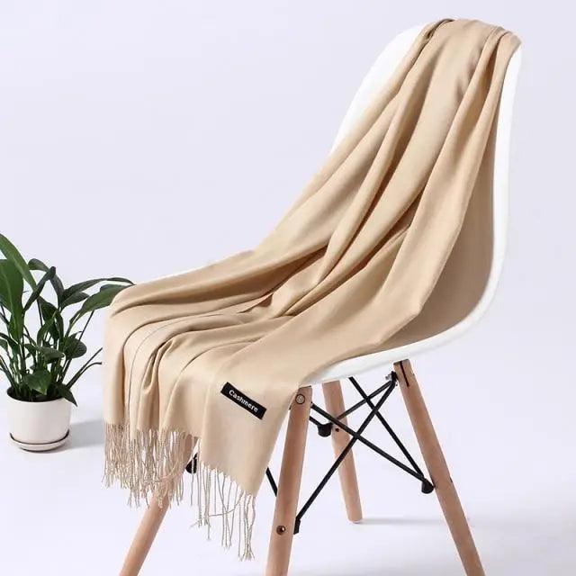 Long winter women's scarf by Stevvex featuring soft, warm fabric, draped around a woman for a cozy, stylish look.