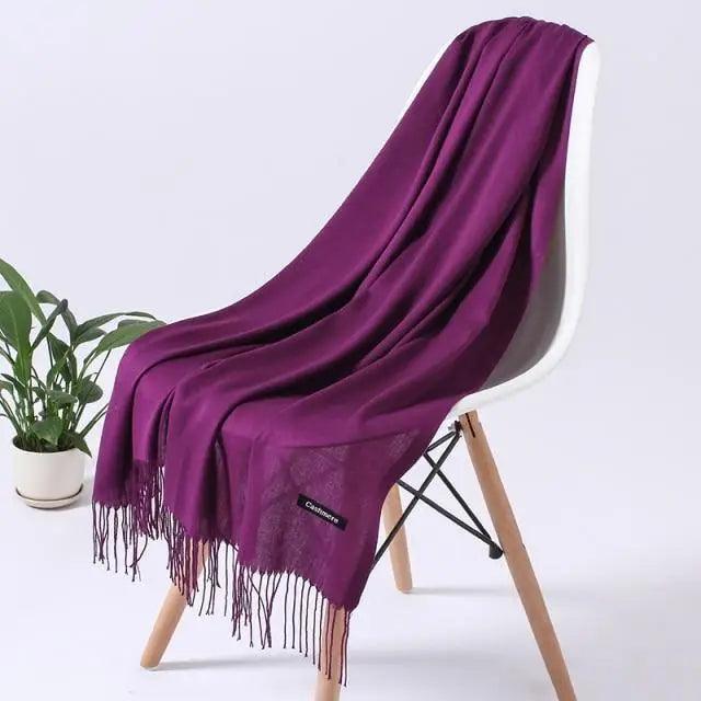 Long soft winter women's scarf by Stevvex, draped around a model, showcasing warm, stylish shawl and wrap for cold weather.