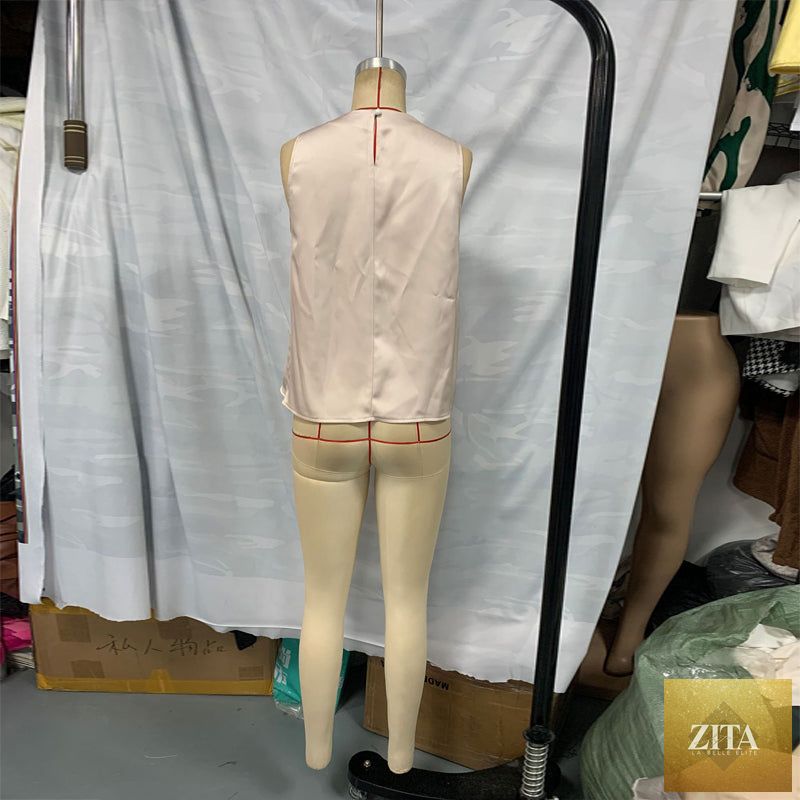 Women's elegant sleeveless mock neck top by FitiqueFit, casualwear, shown in a stylish, fitted design with smooth fabric.
