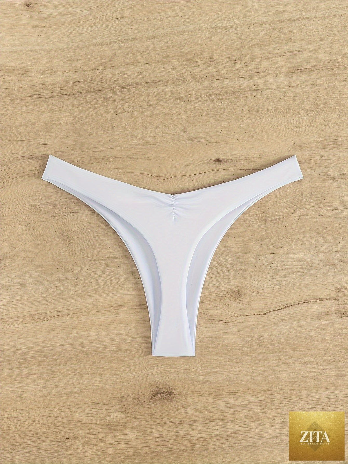 Stevvex solid color cheeky ruched thong bikini bottoms for women, high stretch polyamide swimwear for beach and pool.