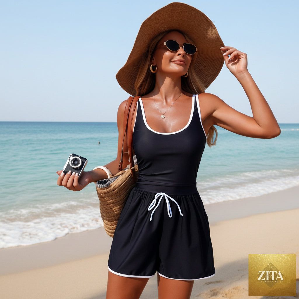 Women's minimalist solid color sleeveless sports one-piece swimsuit by Zita La Belle Elite, shown on a model.