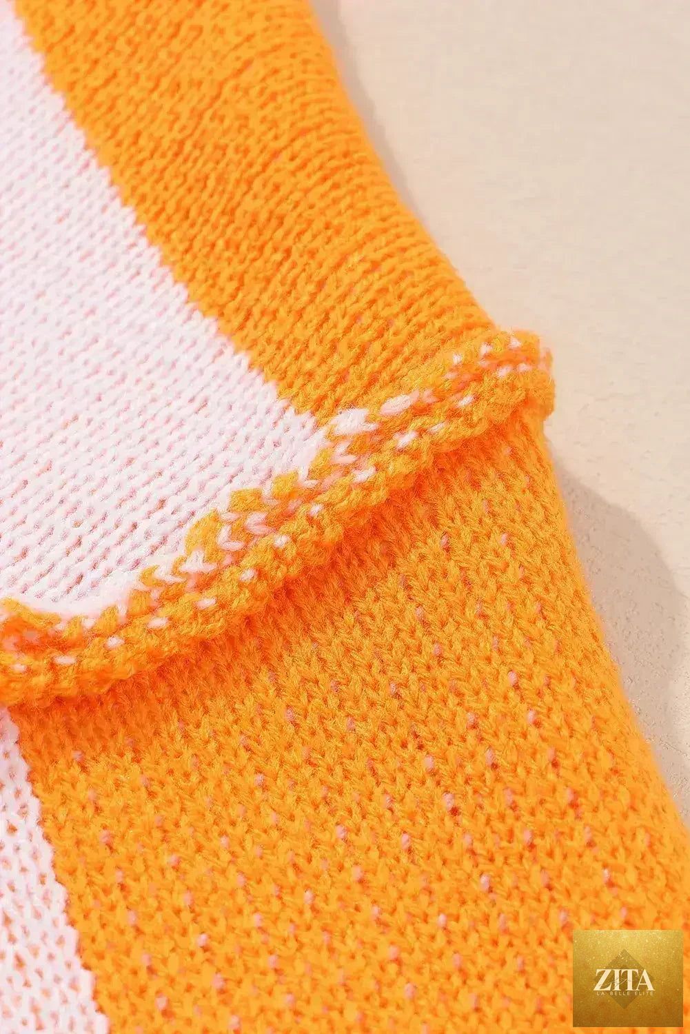 Orange checkered Femstylo sweater with bishop sleeves, featuring a cozy knit and stylish pattern, perfect for casual wear.