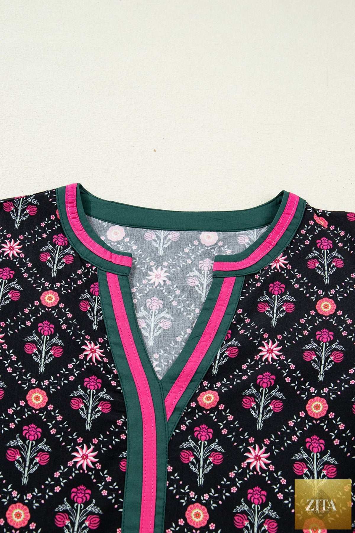Black vintage floral blouse with contrast V-neckline and bracelet sleeves from Wild and Free Boutique, featuring a stylish, feminine design.