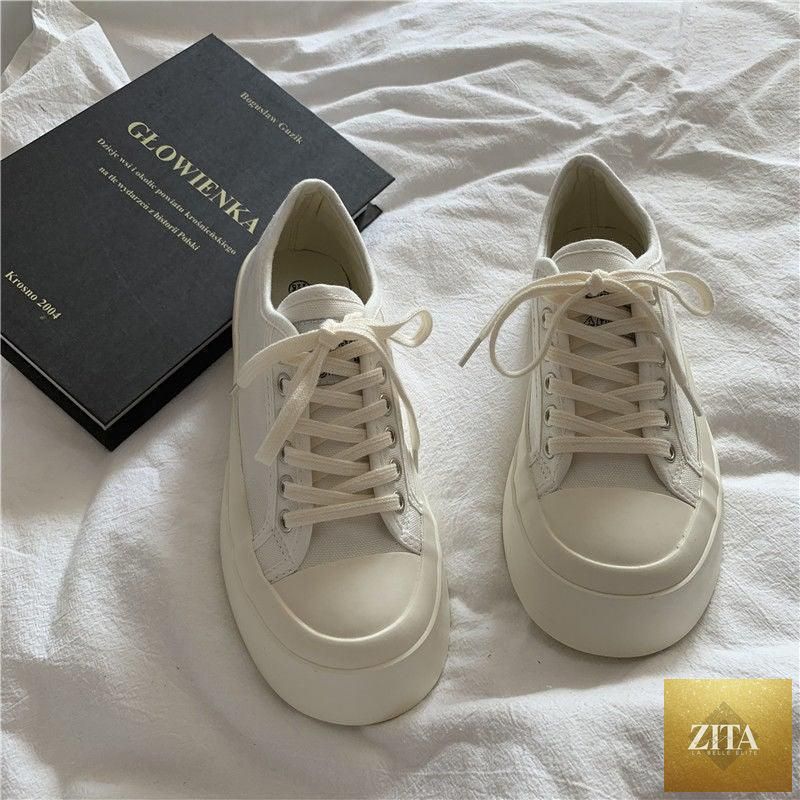 Women's Stevvex white canvas sneakers with flat design, low top, athletic platform, casual vintage style, round toe, and air mesh detail.