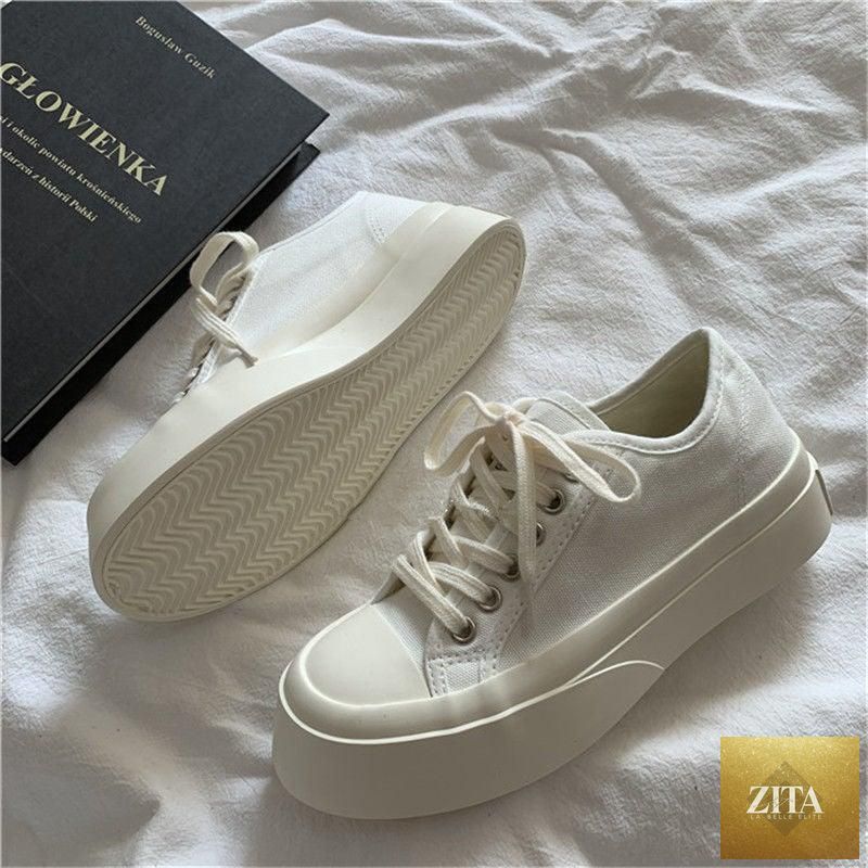 Women's white Stevvex canvas sneakers with low-top design, platform sole, round toe, and athletic vintage casual style.