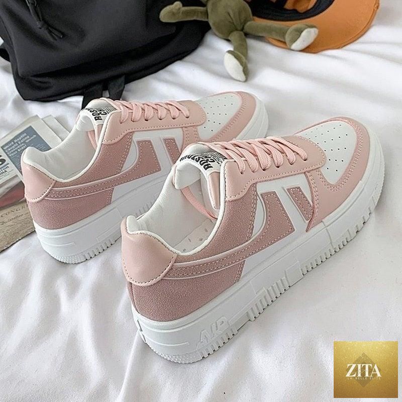 White Stevvex women's casual flat sneakers with lace-up design, breathable fabric, low-top style, ideal for comfortable walking and sports.