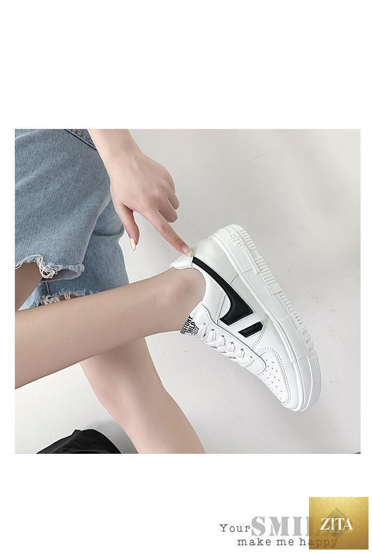 White Stevvex women's casual sneakers with lace-up design, breathable fabric, flat low-top style, ideal for comfortable walking and sports.