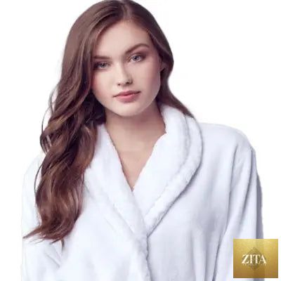 Women's ultra-soft plush bathrobe by Lotus Linen, front view showing cozy white robe with a shawl collar and tied waist.