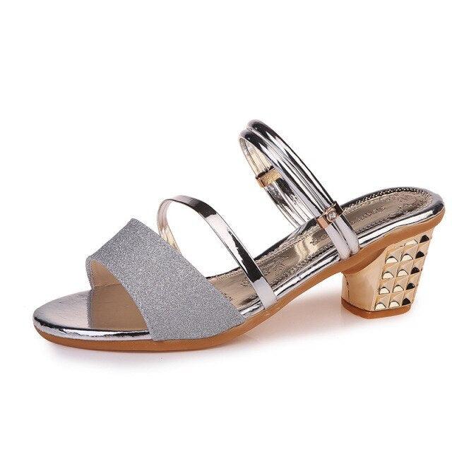 Gold women's summer open-toe sandals with ankle straps, low heels, and stylish design for dressy and party occasions.