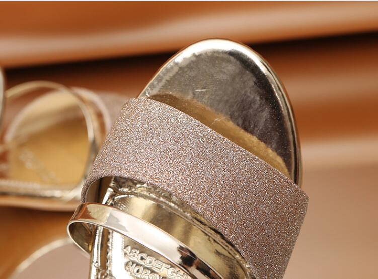 Gold women's summer open-toe sandals with ankle strap, low heels, and fashion-forward design by Stevvex for dress and party wear.