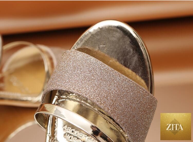Gold women's summer open-toe sandals with ankle strap, low heels, and fashion-forward design by Stevvex for dress and party wear.