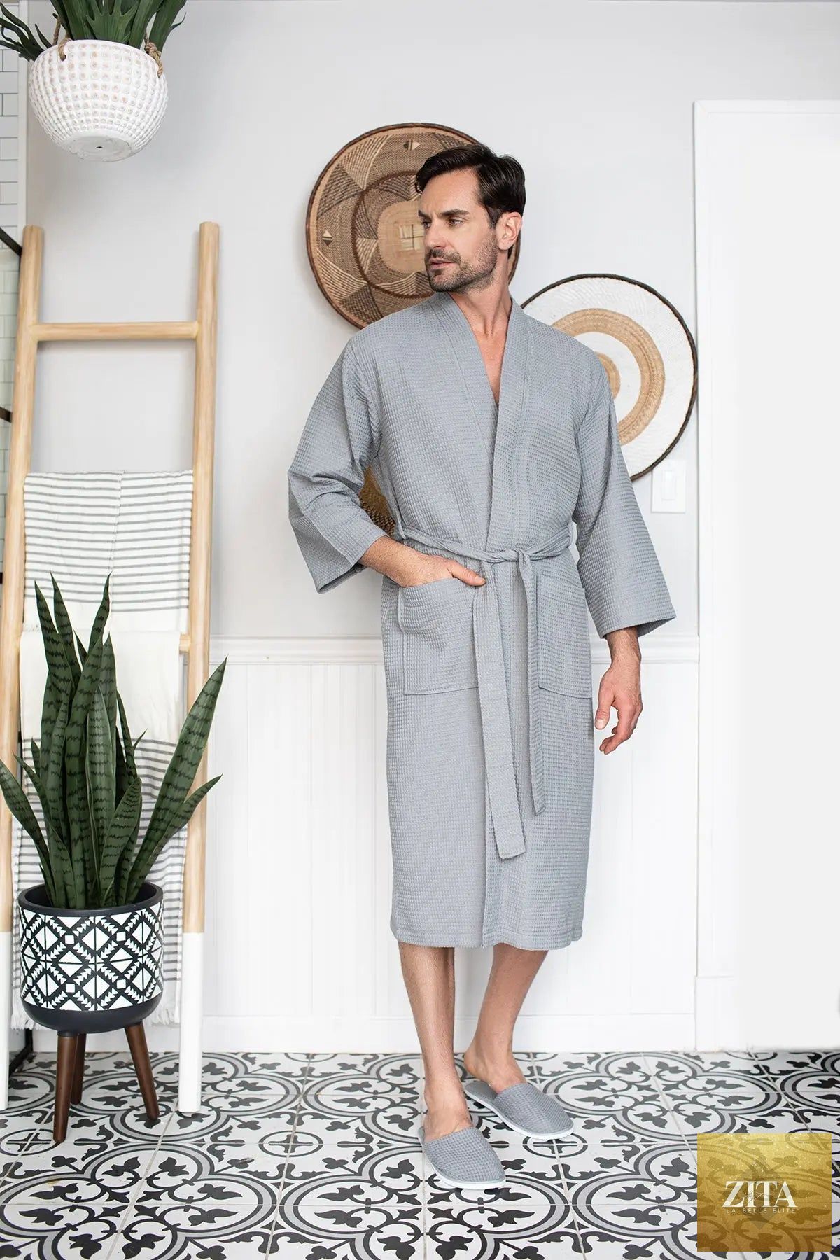 Gray men's waffle spa bathrobe by Lotus Linen, lightweight and absorbent, shown hanging on a hook.