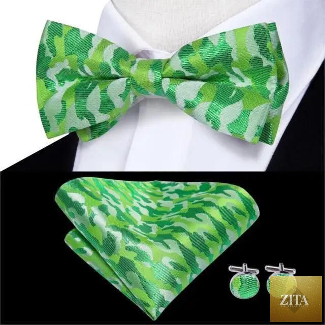 Green silk butterfly pre-tied bow tie, pocket square, and cufflinks set for men, styled with a formal suit from Stevvex.