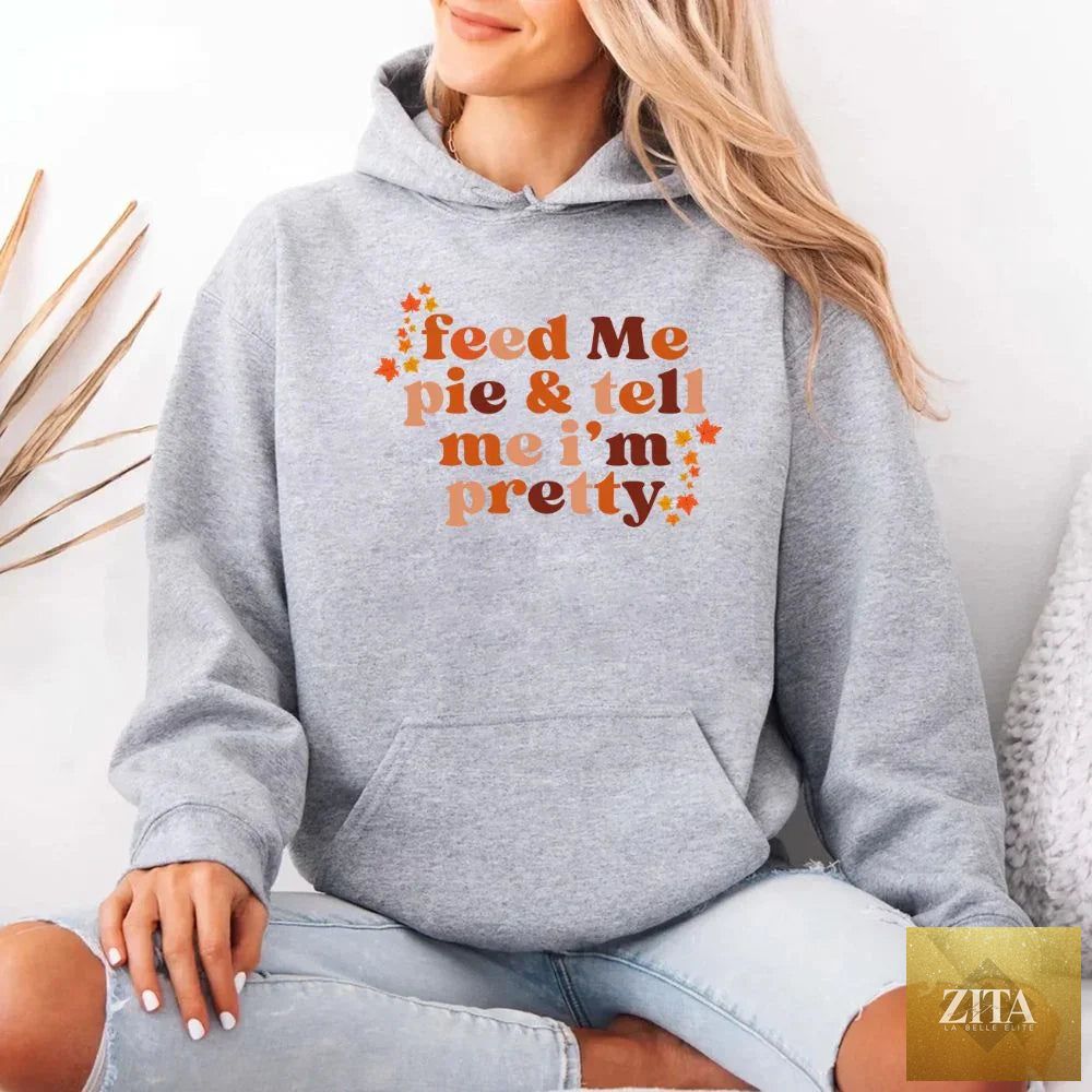 Grey hoodie from Adorb Custom Tees featuring the "Feed Me Pie And Tell Me I'm Pretty" design, casual fall fashion.