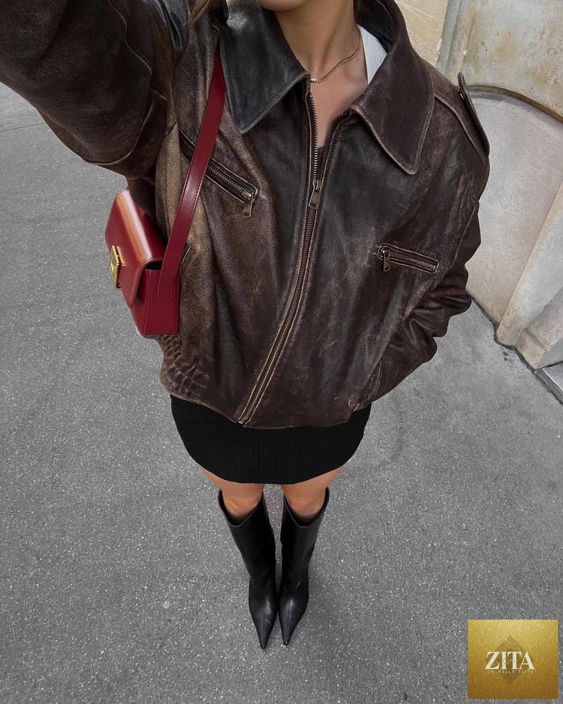 Vintage 90s oversized distressed black leather bomber jacket by Cows Skin Jackets, Parisian street style women’s outerwear.