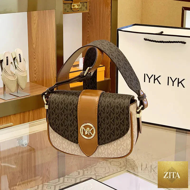 Elegant women's leather saddle bag from Trendy Attic Store, featuring a classic design and adjustable strap.