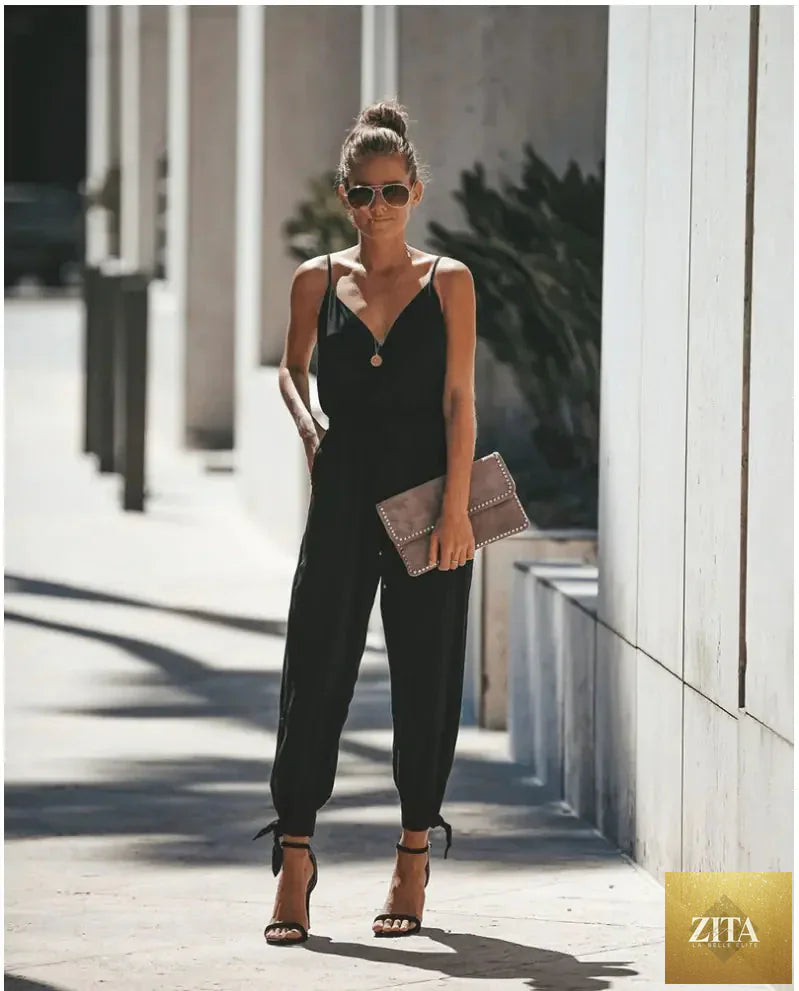 Backless floral print women's jumpsuit with slit design, stylish and comfortable, featuring vibrant flower patterns and a relaxed fit.