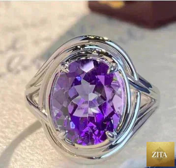 Elegant copper ring with a shimmering amethyst gemstone, showcasing a stylish design by MANDOTOS.