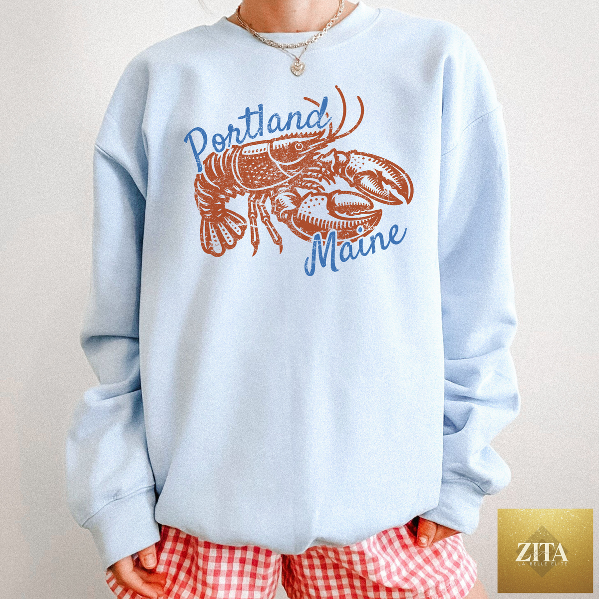 Light blue Portland Maine Lobster Crewneck Sweatshirt by Zita La Belle Elite featuring a coastal lobster graphic design.
